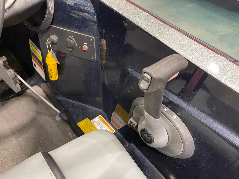 Slide: The Image of Control panel of a 2009 Triton 18 HP Explorer boat with throttle lever. - 21