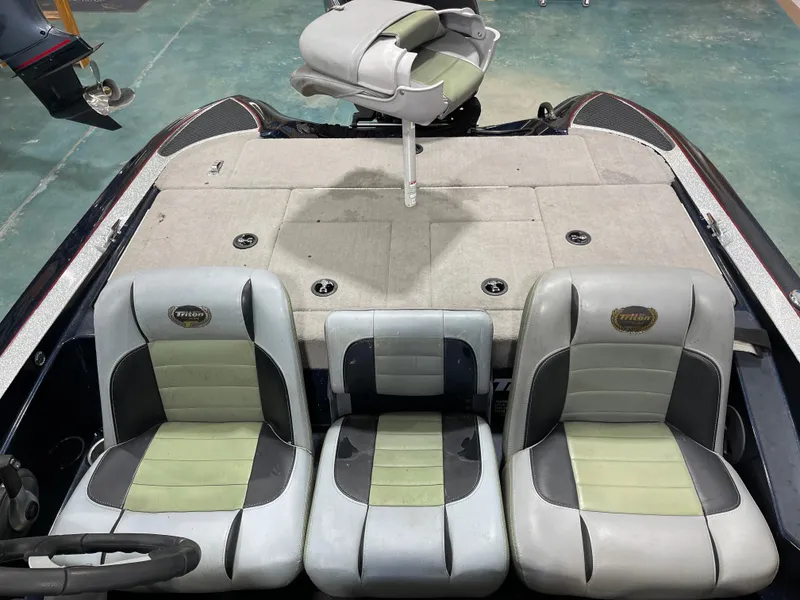 Slide: The Image of 2009 Triton 18 HP Explorer boat interior with three seats and a fishing platform. - 22