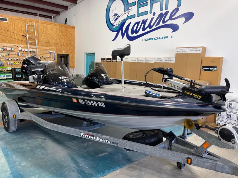 Slide: The Image of 2009 Triton 18 HP Explorer boat on trailer in marine shop. - 5