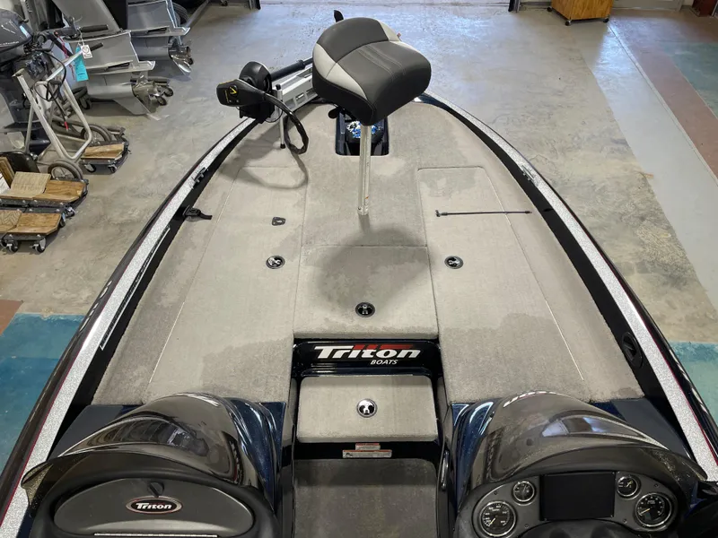 Slide: The Image of 2009 Triton 18 HP Explorer boat interior with seating and controls. - 8