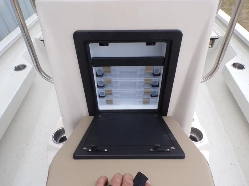 Slide: The Image of 2025 Xpress H20BAY boat storage compartment with organized tackle boxes. - 10