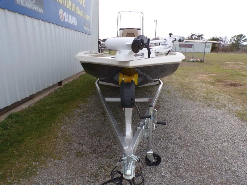 Slide: The Image of 2025 Xpress H20BAY boat on trailer, parked outdoors near a building. - 16