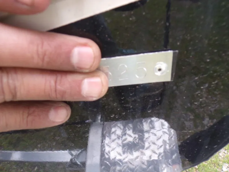 Slide: The Image of Close-up of a hand holding a metal plate on a 2025 Xpress H20BAY boat. - 3