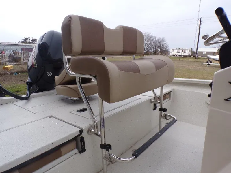 Slide: The Image of 2025 Xpress H20BAY boat interior with cushioned seating and motor. - 7