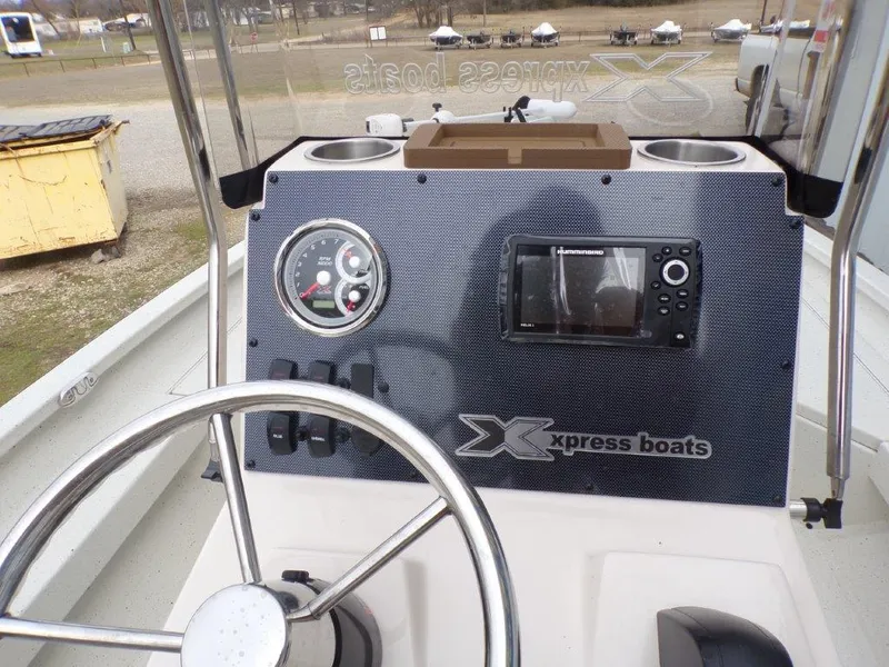 Slide: The Image of 2025 Xpress H20BAY boat dashboard with steering wheel and navigation controls. - 9