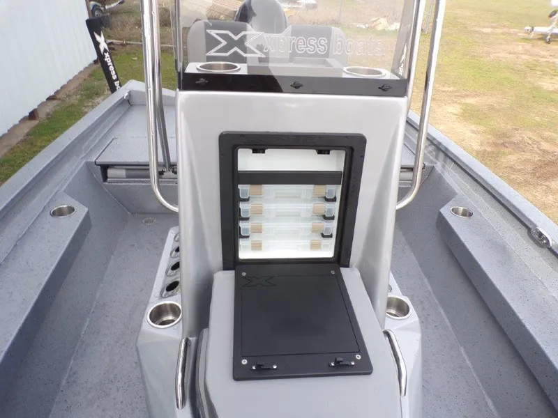 Slide: The Image of 2025 Xpress H20BAY boat interior with storage compartment and rod holders. - 12