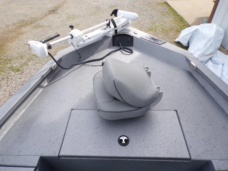 Slide: The Image of 2025 Xpress H20BAY boat with gray seating and trolling motor on deck. - 14