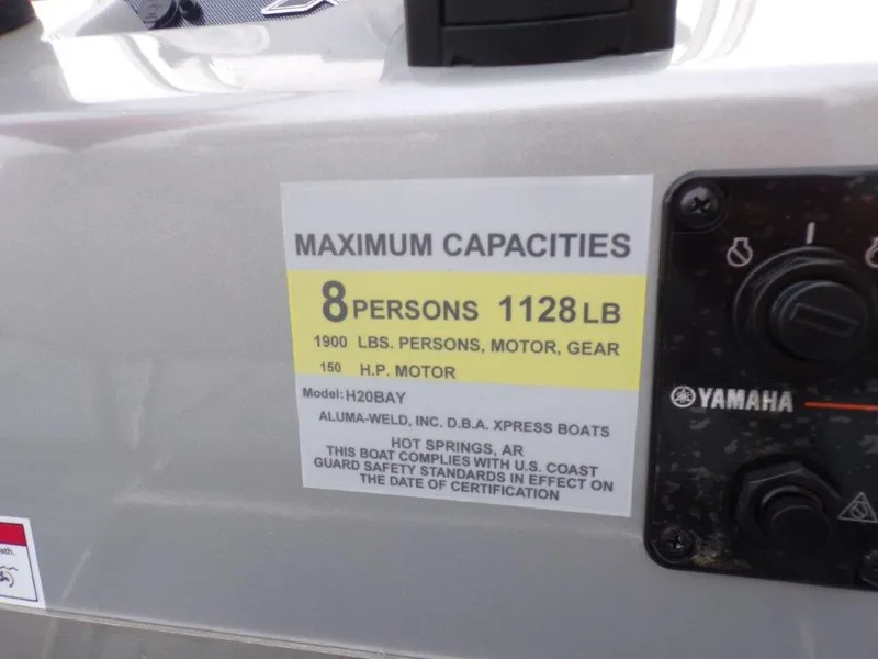 Slide: The Image of Capacity label on 2025 Xpress H20BAY boat, max 8 persons, 1128 lbs. - 3