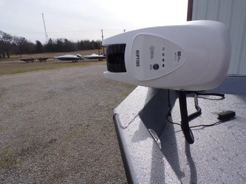 Slide: The Image of 2025 Xpress H20BAY boat with Riptide trolling motor in outdoor setting. - 4