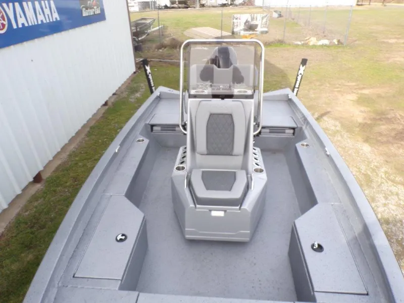 Slide: The Image of 2025 Xpress H20BAY boat interior with center console and seating, displayed outdoors. - 5