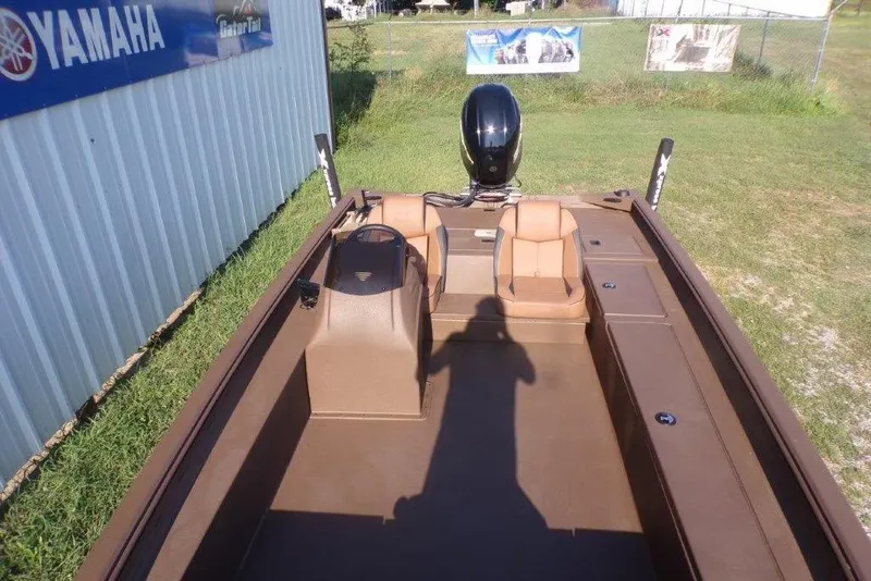 Slide: The Image of 2026 Xpress XP200 boat interior with dual seats and Yamaha engine, parked on grass. - 19