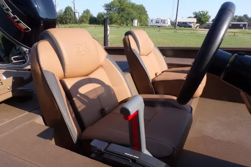 Slide: The Image of 2026 Xpress XP200 boat interior with tan seats and steering wheel. - 23