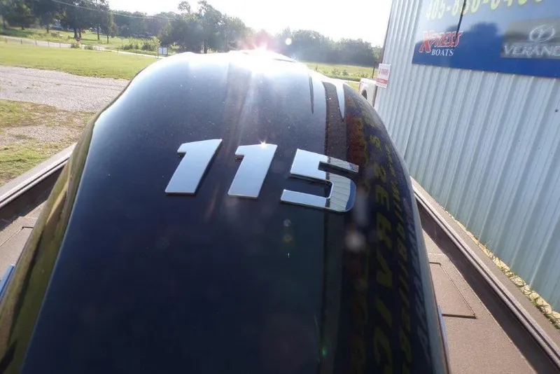 Slide: The Image of 2026 Xpress XP200 boat engine cover with "115" decal, outdoor setting. - 9