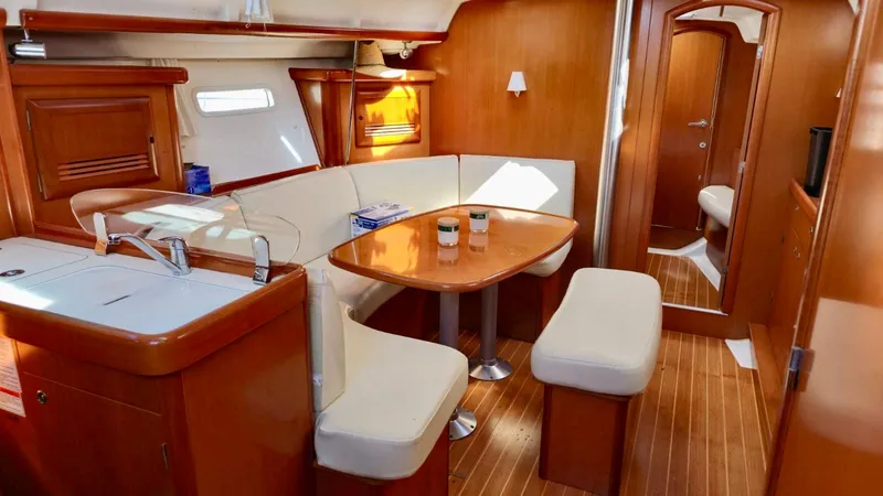 Slide: The Image of Interior of 2006 Beneteau 393 yacht with wooden finish and cozy seating area. - 20