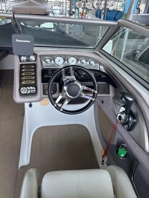 Slide: The Image of 2005 Cobalt 272 boat dashboard with steering wheel and Raymarine navigation system. - 14