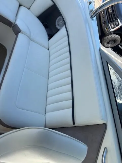 Slide: The Image of 2005 Cobalt 272 boat interior with white cushioned seating and sleek design. - 22