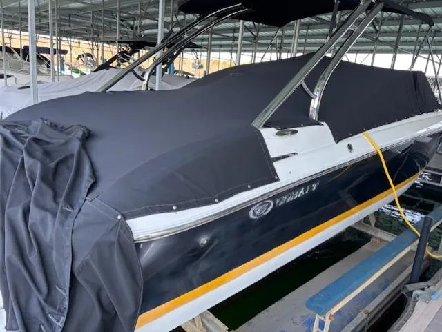 Slide: The Image of 2005 Cobalt 272 boat covered in black tarp, docked in a marina. - 5