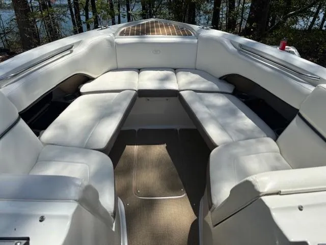 Slide: The Image of 2005 Cobalt 272 boat interior with white cushioned seating and lake view. - 9