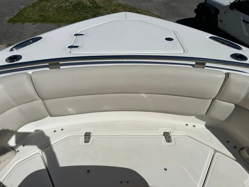 Slide: The Image of 2021 Boston Whaler Realm 380 boat bow with cushioned seating and storage compartments. - 10