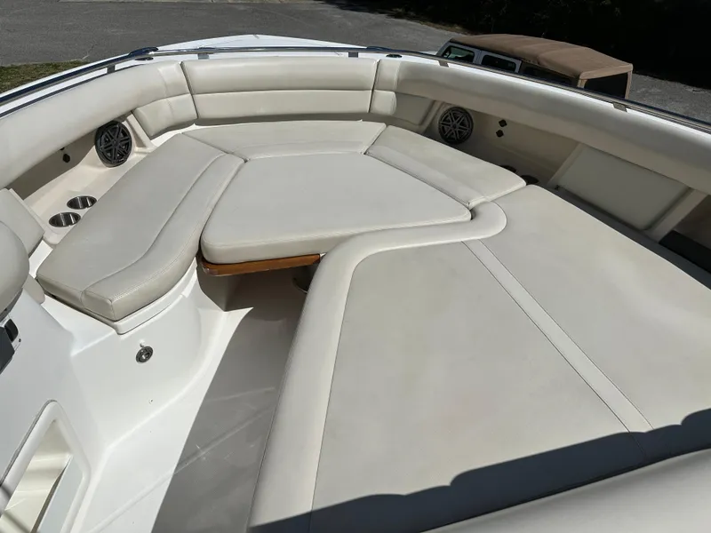 Slide: The Image of 2021 Boston Whaler Realm 380 boat interior with cushioned seating area. - 17