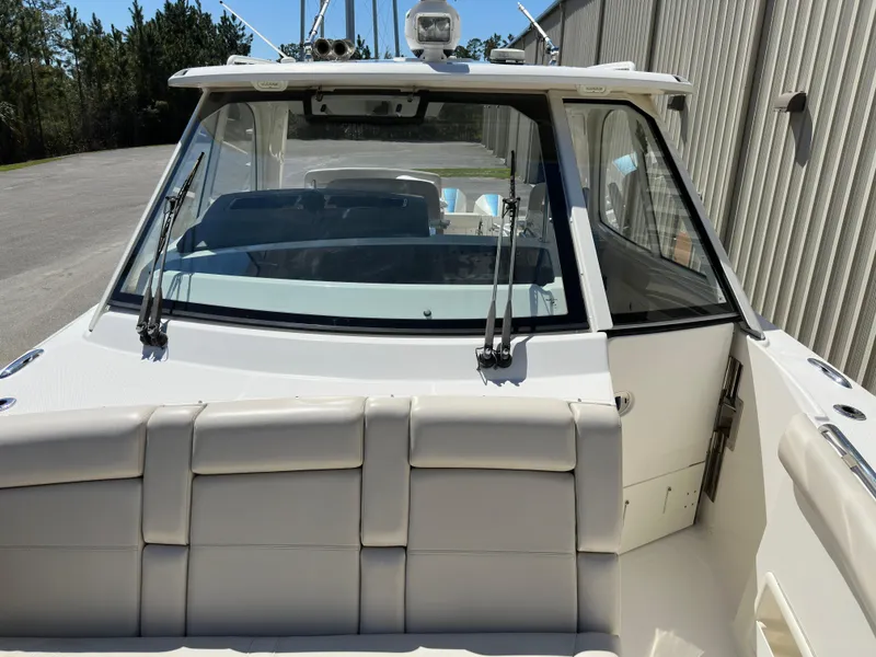 Slide: The Image of 2021 Boston Whaler Realm 380 boat, rear view, showcasing seating and windshield. - 20