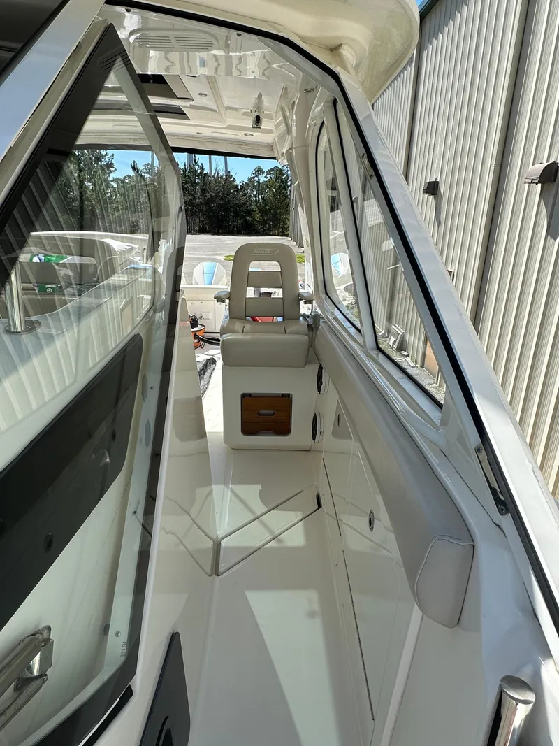 Slide: The Image of 2021 Boston Whaler Realm 380 boat interior with seating and sleek design. - 23