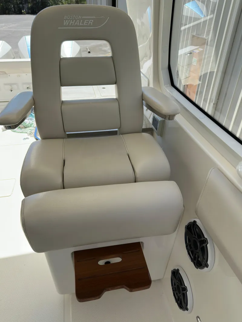Slide: The Image of 2021 Boston Whaler Realm 380 captain's chair with armrests and footrest, interior view. - 25