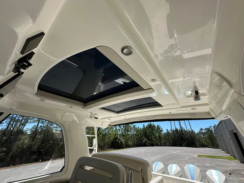 Slide: The Image of 2021 Boston Whaler Realm 380 interior roof with sunroof and seating, showcasing luxury design. - 28