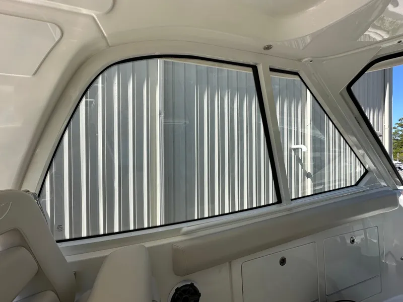 Slide: The Image of Interior view of 2021 Boston Whaler Realm 380 boat, showcasing window and seating area. - 32