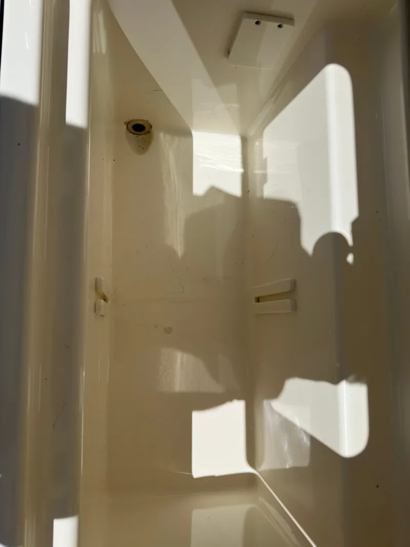 Slide: The Image of 2021 Boston Whaler Realm 380 interior compartment, showcasing clean, spacious design. - 43