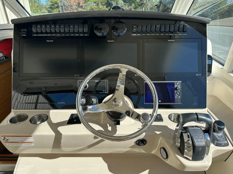 Slide: The Image of 2021 Boston Whaler Realm 380 helm with modern controls and navigation displays. - 47