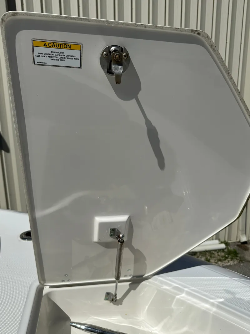 Slide: The Image of Open hatch on a 2021 Boston Whaler Realm 380 boat, showing interior mechanism. - 8