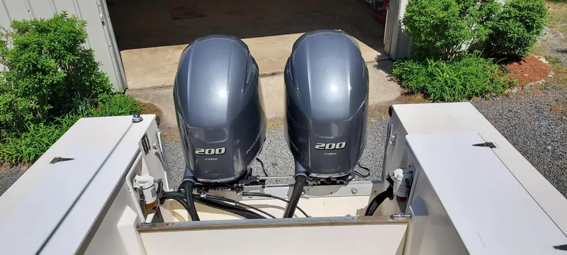 Slide: The Image of Twin 200 horsepower outboard engines on a 1990 Mako 261 Center Console boat. - 12