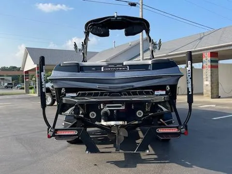 Slide: The Image of 2019 Centurion Ri237 boat, rear view, parked outdoors. - 2