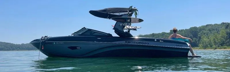 Slide: The Image of 2019 Centurion Ri237 boat on a lake with a person relaxing on the deck. - 3