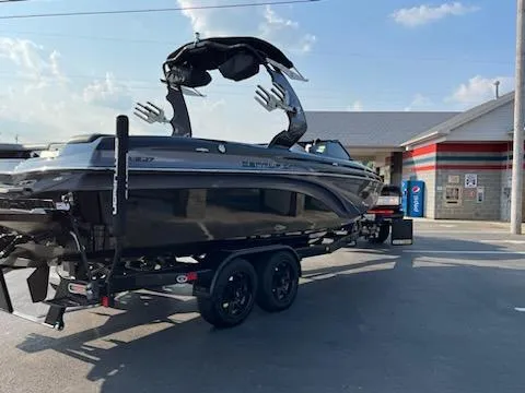 Slide: The Image of 2019 Centurion Ri237 boat on trailer near convenience store, sunny day. - 5