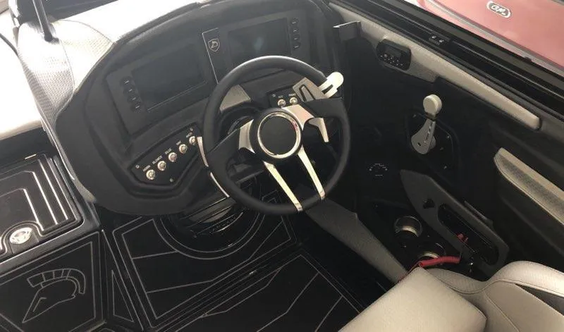 Slide: The Image of 2019 Centurion Ri237 boat cockpit with modern steering wheel and control panel. - 6