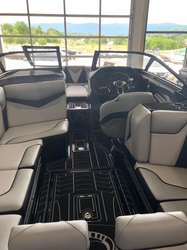 Slide: The Image of 2019 Centurion Ri237 boat interior with sleek seating and modern dashboard design. - 7