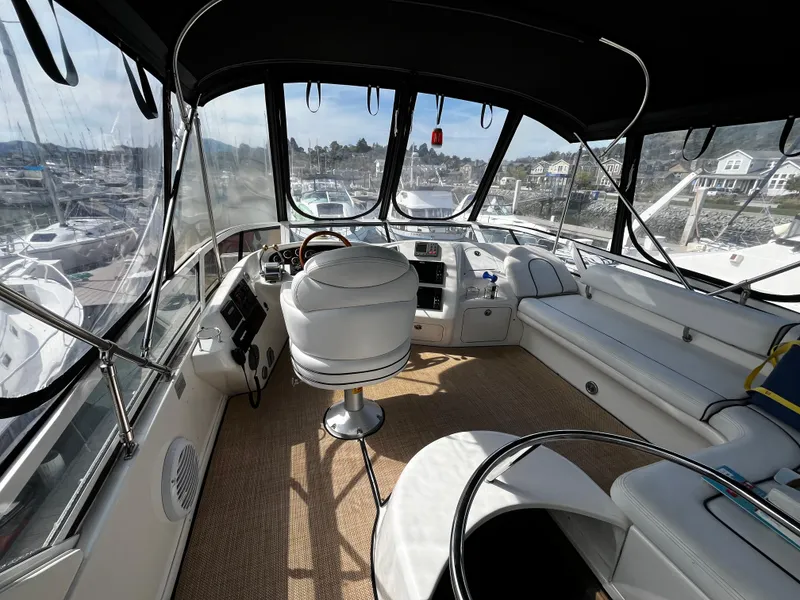 Slide: The Image of 2001 Sea Ray 420 Aft Cabin yacht interior with helm and seating area. - 15