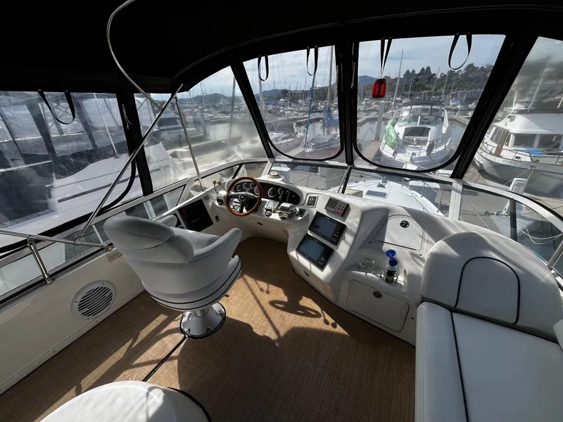 Slide: The Image of Helm of 2001 Sea Ray 420 Aft Cabin yacht with modern controls and panoramic view. - 21