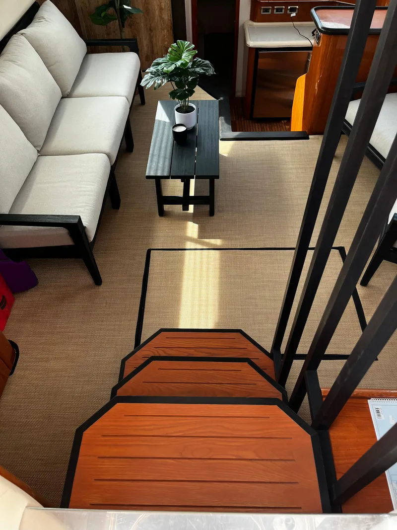 Slide: The Image of Interior of 2001 Sea Ray 420 Aft Cabin with modern seating and decor. - 25