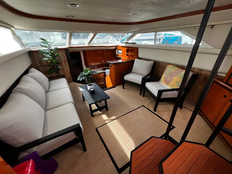 Slide: The Image of Luxurious interior of 2001 Sea Ray 420 Aft Cabin yacht with modern seating and decor. - 26
