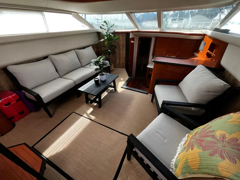 Slide: The Image of Interior of 2001 Sea Ray 420 Aft Cabin with cozy seating and natural light. - 27