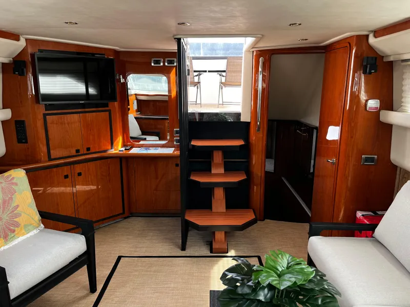 Slide: The Image of Interior of 2001 Sea Ray 420 Aft Cabin yacht with wooden cabinetry and seating. - 29