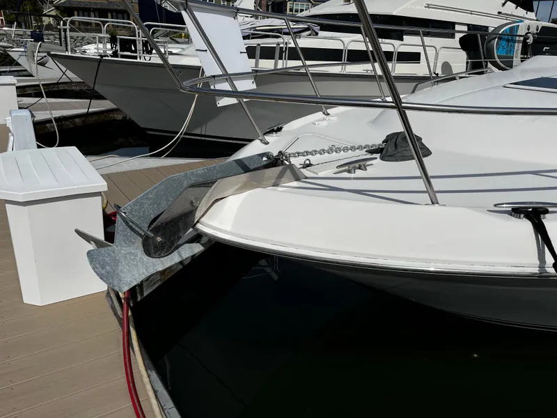 Slide: The Image of 2001 Sea Ray 420 Aft Cabin yacht docked at marina, showcasing anchor and bow details. - 3