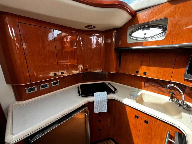 Slide: The Image of Luxurious kitchen interior of 2001 Sea Ray 420 Aft Cabin yacht with wood cabinetry. - 33
