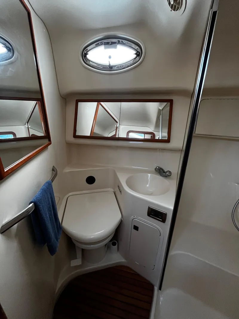 Slide: The Image of Bathroom interior of 2001 Sea Ray 420 Aft Cabin yacht, featuring compact design and porthole window. - 37