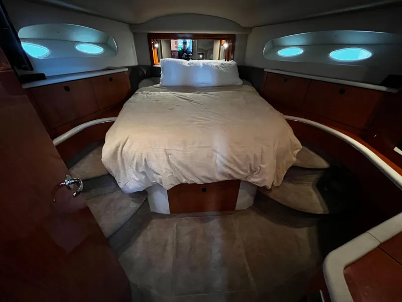 Slide: The Image of 2001 Sea Ray 420 Aft Cabin bedroom with cozy bed and wooden cabinetry. - 39