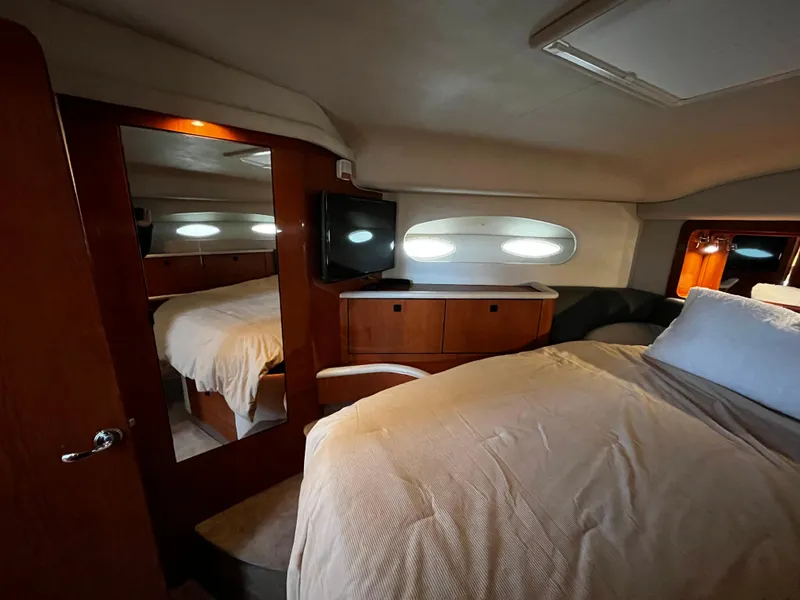 Slide: The Image of Interior of 2001 Sea Ray 420 Aft Cabin with cozy bedroom and wooden cabinetry. - 41