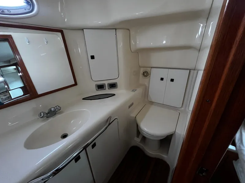Slide: The Image of 2001 Sea Ray 420 Aft Cabin bathroom with sink, toilet, and storage cabinets. - 43